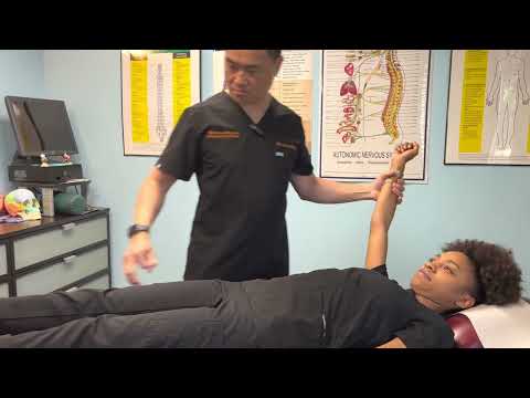 BLACK BELT CHIROPACTOR using Applied Kinesiology Technique to adjust a patient.