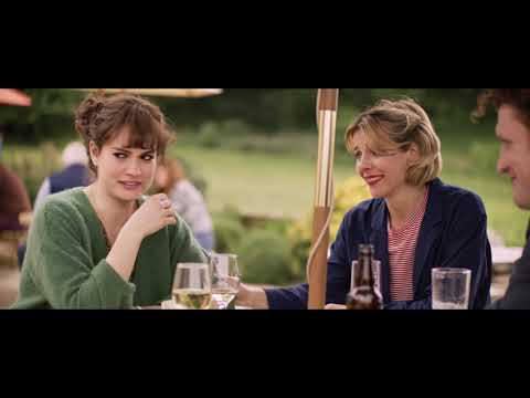 Trailer still of Jack and Ellie riding side by side on bicycles at dusk