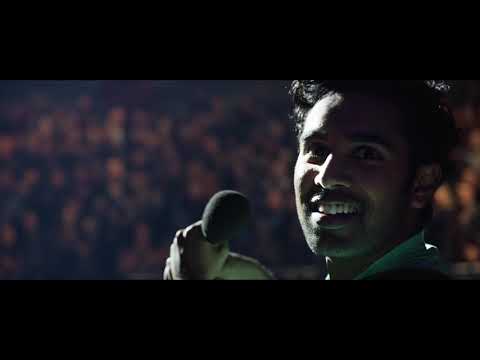 Trailer montage still of Wembley Stadium with lights up as the crowd sings along