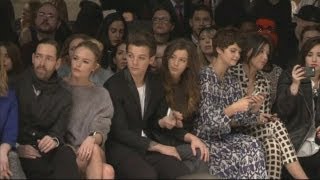 One Direction's Louis Tomlinson brings girlfriend to the Topshop show and Cara Delevingne models