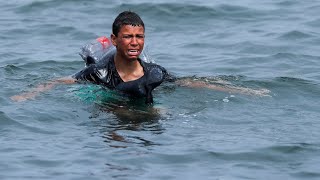 Ceuta: Migrant boy swims to shore with plastic bot