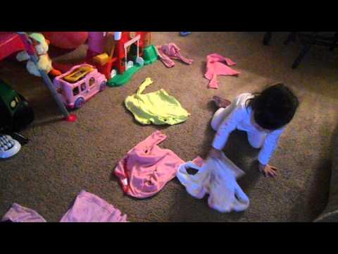 Hannah picking up her clothes