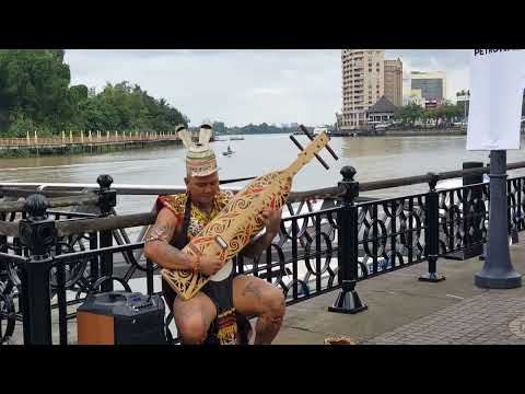 Playing a Sape', a guitar like instrument by native of Borneo musician.