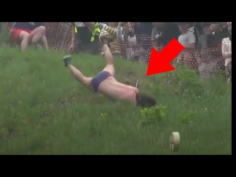 People chasing cheese downhill in slow motion to the sound of Ave Maria