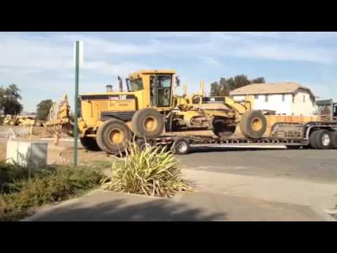 Loading CATERPILLAR 14H Motor Grader onto Lowboy