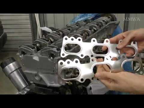 Red W124's exhaust manifolds installed