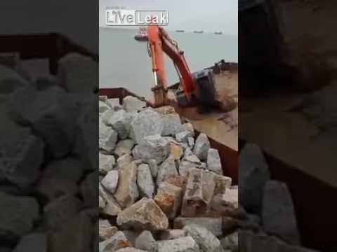 Excavator operator desperately works to save a barge and his life.