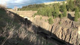preview picture of video 'BNSF westbound coal train with helper set exits Bozeman tunnel 19 May 2010'