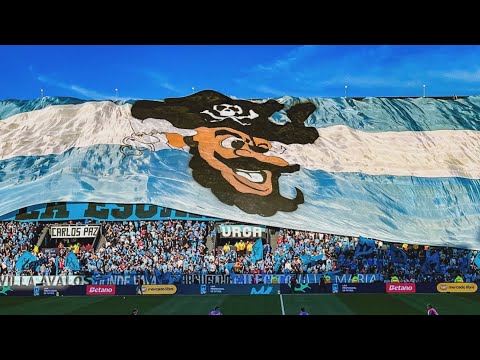 "SIEMPRE PRESENTES CAMPEÓN" Barra: Los Piratas Celestes de Alberdi &bull; Club: Belgrano &bull; País: Argentina