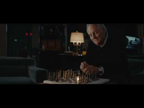 Finale-tinged trailer frame: the Ferrari and a wink of brass from the end titles