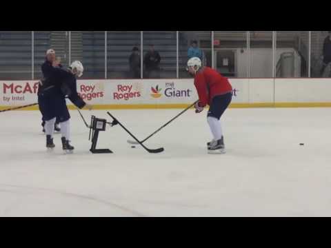 Capitals Kevin Shattenkirk and Evgeny Kuznetsov play against robot