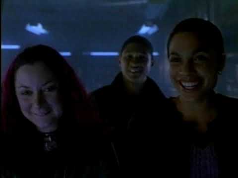 Trailer still with police lights and school facade, suggesting tense hip-hop underscoring