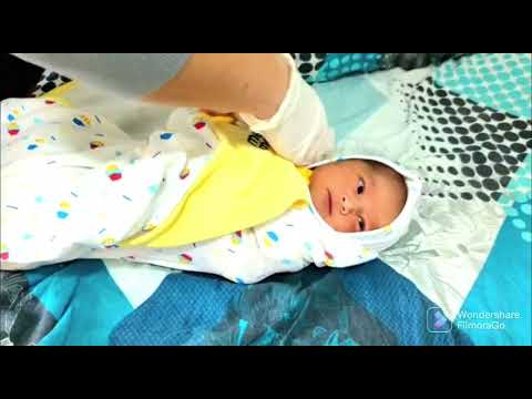 Baby Swaddling. Nurse gives baby a proper swaddle. Day 3 of life.