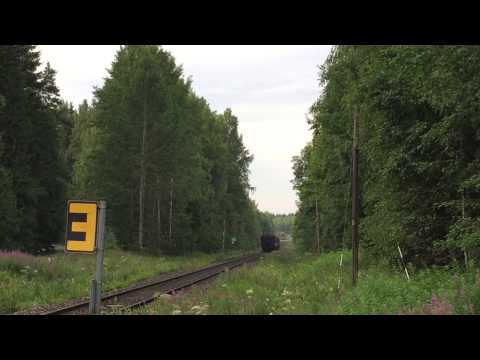 Finnish museum train pulled by class Dr13 heading to Hyvinkää at Tervamäentie level crossing.