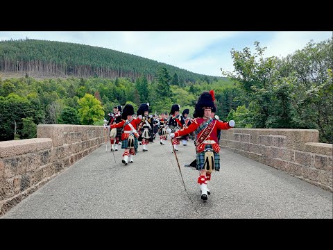 Scotland the Brave as massed Pipe Bands march over river Dee to 2024 Ballater Games in Scotland