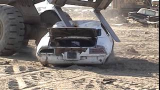 Old forgotten 1970s Classic Pontiac Firebird being torn apart and destroyed,