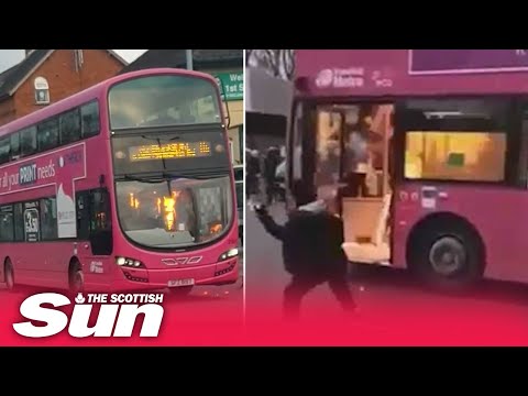 Belfast rioters hijack and firebomb bus