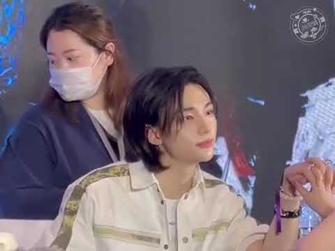 Hyunjin staring and holding hand of fan at fanmeet in China