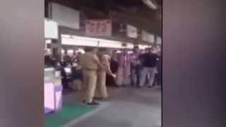 Shocking footage shows two police officers violently brawling in the middle of public market
