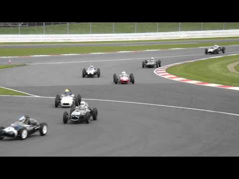 Historic Formula 1 cars including a shark nose Ferrari