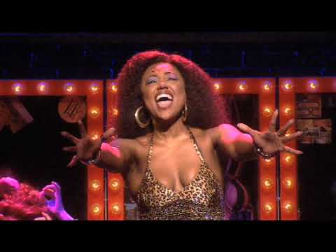 Trailer close-up: Deloris conducts a full-tilt choir as brass hit a staccato break in Spread the Love Around