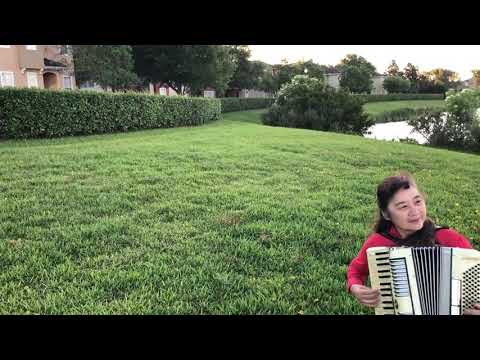 Shan Liu Playing Accordion by the Lake