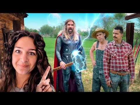 Woman in the foreground points at a Thor-like superhero summoning blue lightning in a rural yard, with two farmers nearby and a wooden barn behind them.