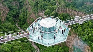 Tourists flock to 240-metre glass bridge across canyon