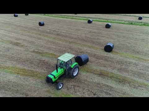 Deutz and John Deere tractors making silage .