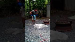 Breaking rock with jack hammer at camp