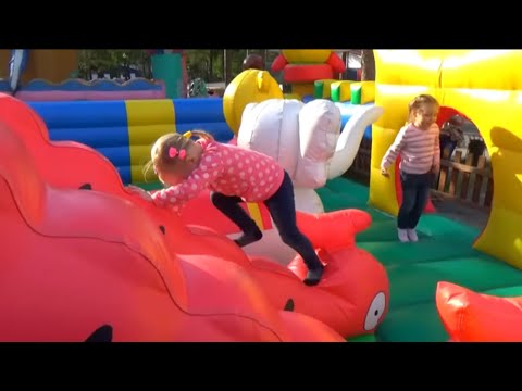 Alice plays in the park with her favorite toys for children Алиса играет в парке с игрушками