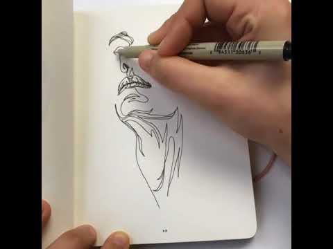 Artist draws a face in one continuous line.