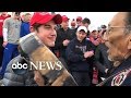 Confrontation between teenager wearing MAGA hat and Native American protestor