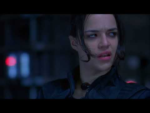 Trailer still: Umbrella train tunnel with sparks; album’s metal cuts echo the action beat