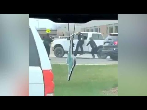 Video shows Hutchinson police officer hanging on truck as suspect attempts to flee from traffic stop