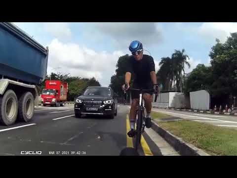 Reckless BMW SLM5866A squeezes between truck and cyclists