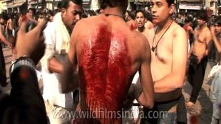 Shia devotees beat themselves with chains and blades in India video