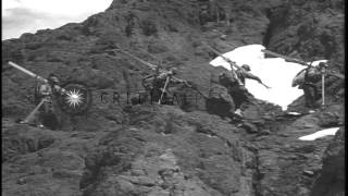 The skiers arriving near a rock and demonstrate the rock climbing techniques in t...HD Stock Footage