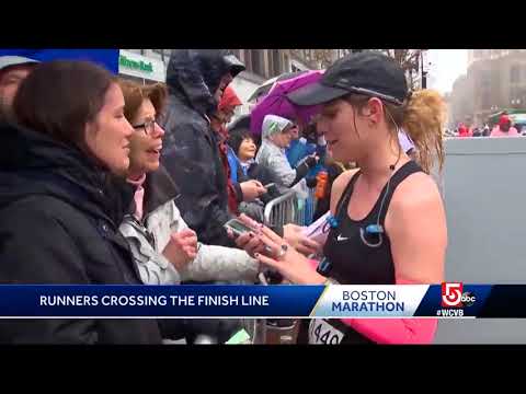 Runners cross the finish line in harsh weather