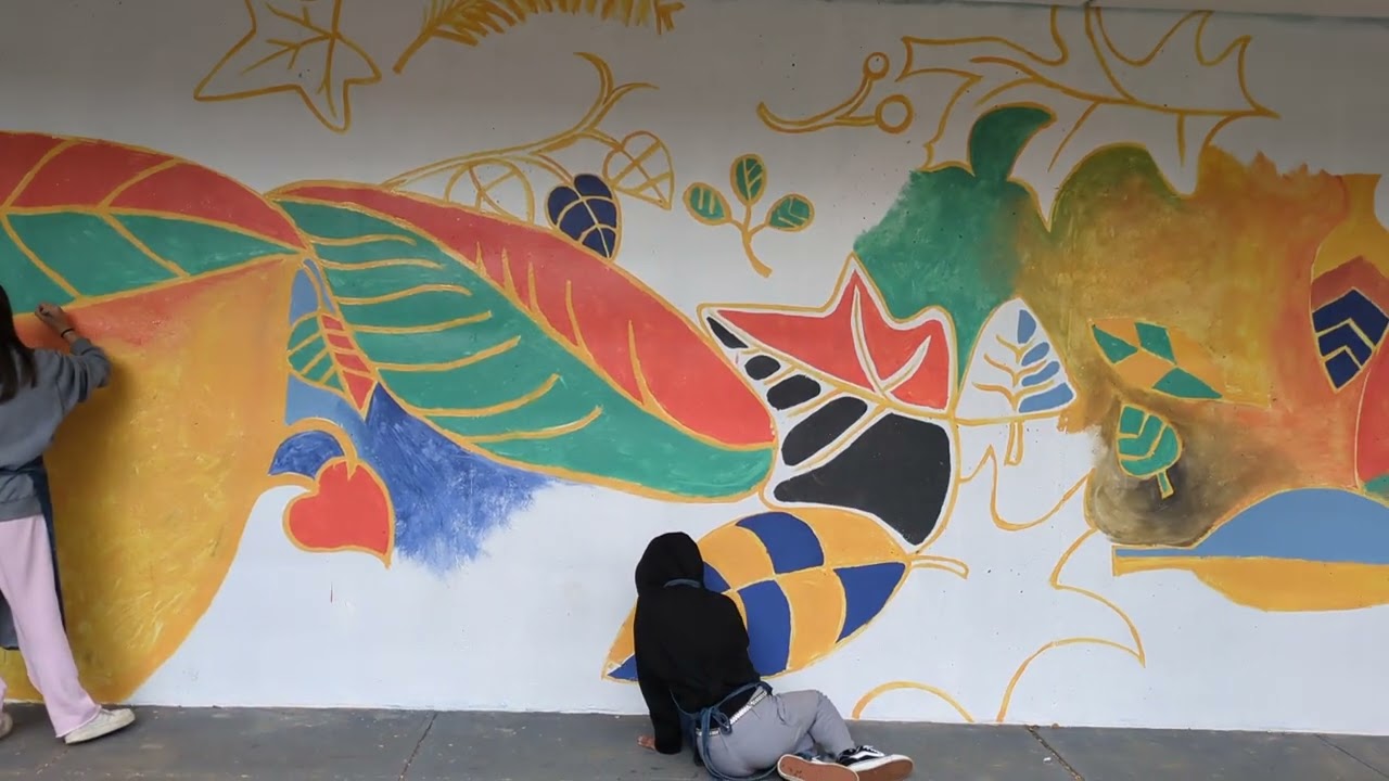 Video preview image of Muralist Chicho Lorenzo working with CHS Art 1 students on new mural for the outdoor courtyard. ; click to visit the ParentSquare post with the video