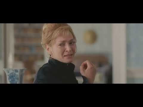 Close-up trailer still of Robert Pattinson as Georges Duroy framed against opulent décor
