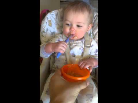 Mackenzie learning to use a spoon