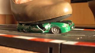 Ximenia crushes a slotcar on a racetrack (crush crushing stomp stomping zertreten ecrasement)