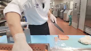 guy preparing fish at work while DMCA music plays in the background