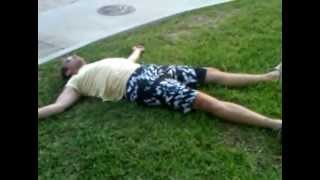 preview picture of video 'Drunk man laying in the grass.'
