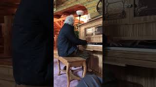 Tom Waits playing a piano on the set of The Ballad of Buster Scruggs in 2018