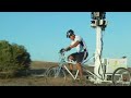 A trike with cameras attached being ridden down a street