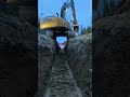 Hopping Off Ditch in an Excavator