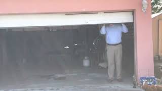 Greg Hill v. St. Lucie Sheriff’s Office: Police Expert Inspecting Garage Door Hill Shot Behind 2