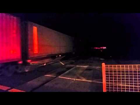 Pacific National 13 PN013 hauls freight though Sherwood level crossing.